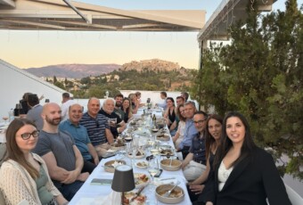 HERON CoE and KIT members at the appreciation dinner, continuing the exchange in an informal setting with a view of the Acropolis.