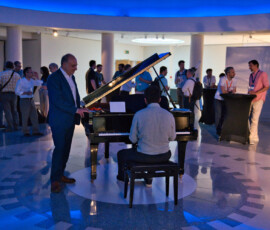 Prof. Petros Maragos enjoying the piano performance by HERON researcher Georgios Chatzichristodoulou during the Welcome Reception at HRF 2026.